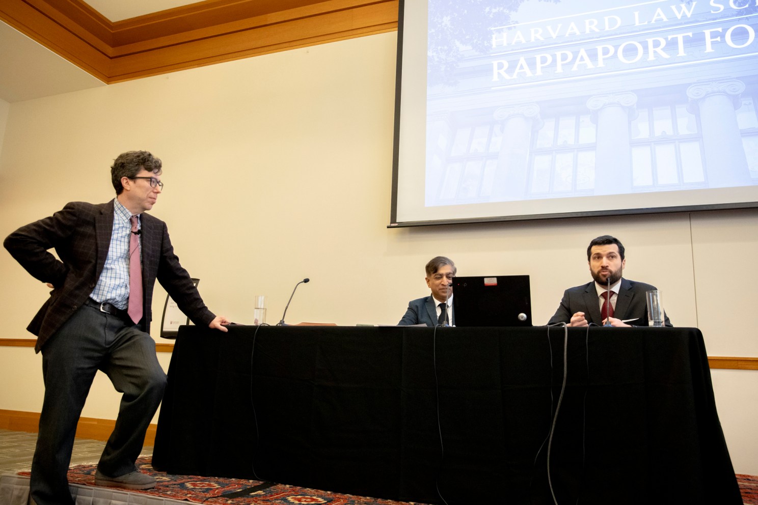 Alan Rozenshtein (right) Jonathan Zittrain (standing), and nupam Chander, a professor of law.