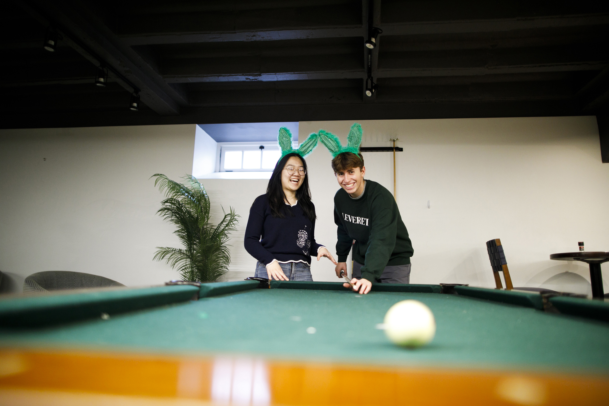 Carly Chen (left) and Hayden Graham are pictured in the Rabbit Hole, a large gathering space on the lower level of McKinlock Hall at Leverett House.