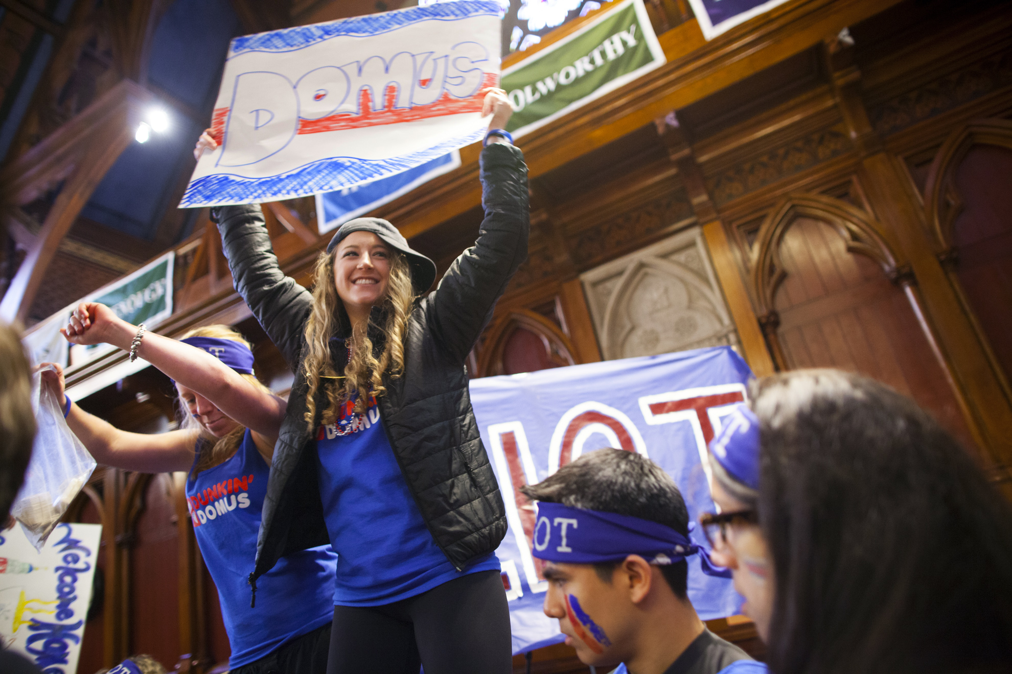 Students show their Eliot House spirit waving the Domus sign.