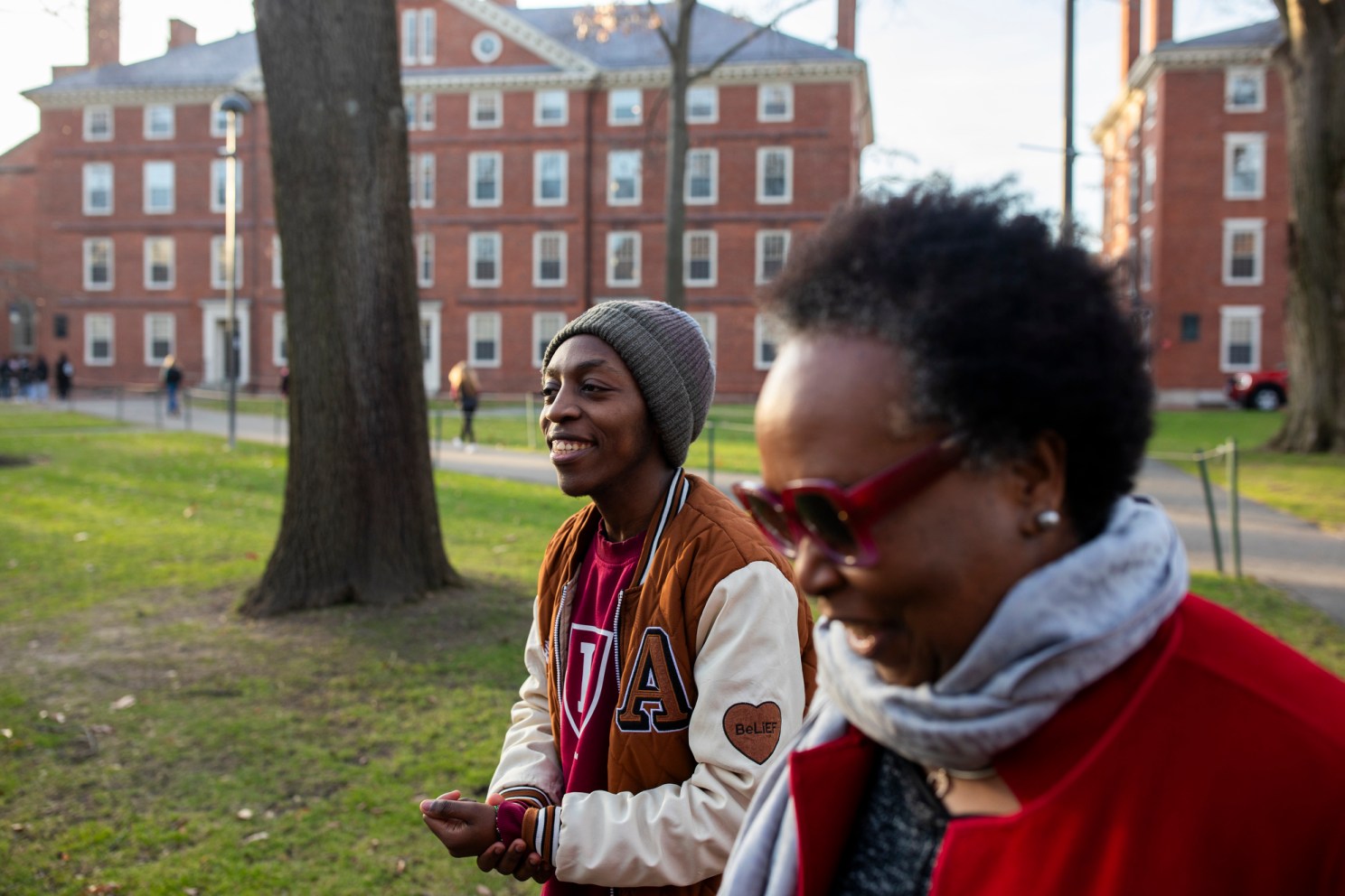 Emmanuel Muriuki (left), walks with Sheila Thimba through Harvard Yard. 