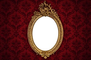 Mirror set in ornate gold frame.