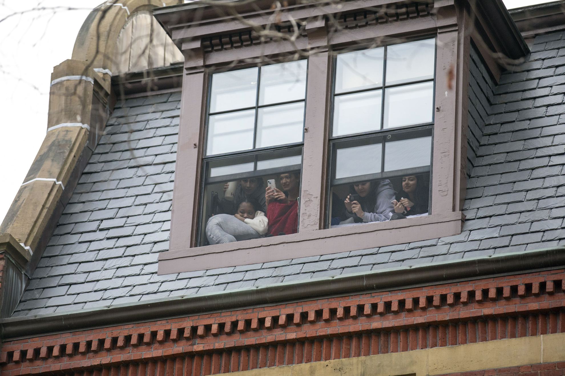 First-years watch Housing Day festivities below their residence hall.