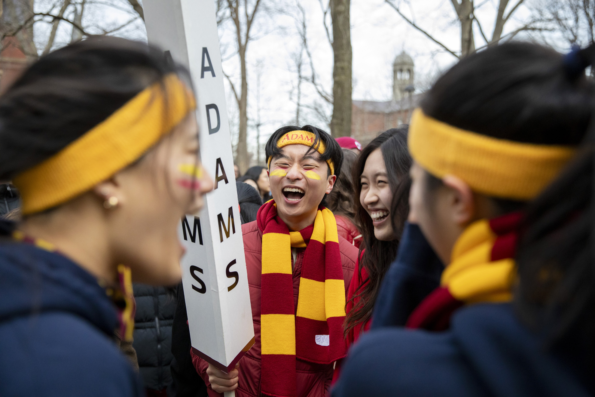 Jeffrey Yang (center), ’26, laughs with his fellow Adams House residents.