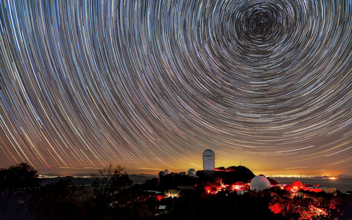 The Mayall Telescope at the Kitt Peak National Observatory in Arizona, shown here beneath star trails.
