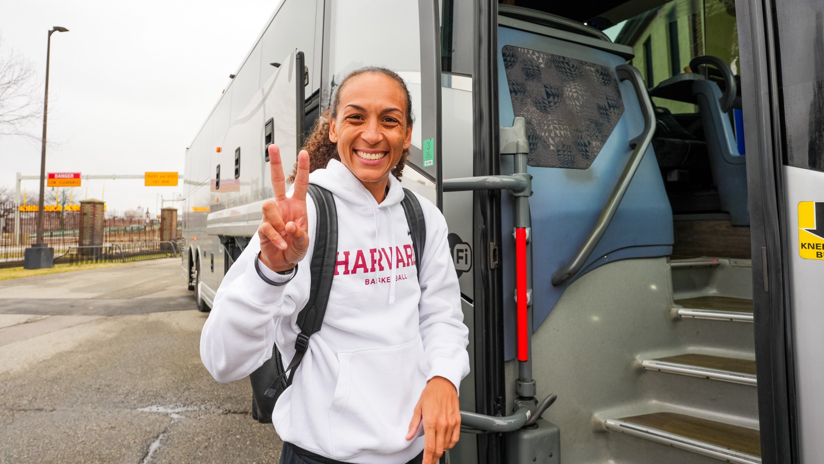 Coach Carrie Moore getting on the bus with her team.