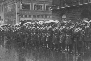 Soldiers from the Black 92nd Infantry Division line up in the rain in New York City following World War I.