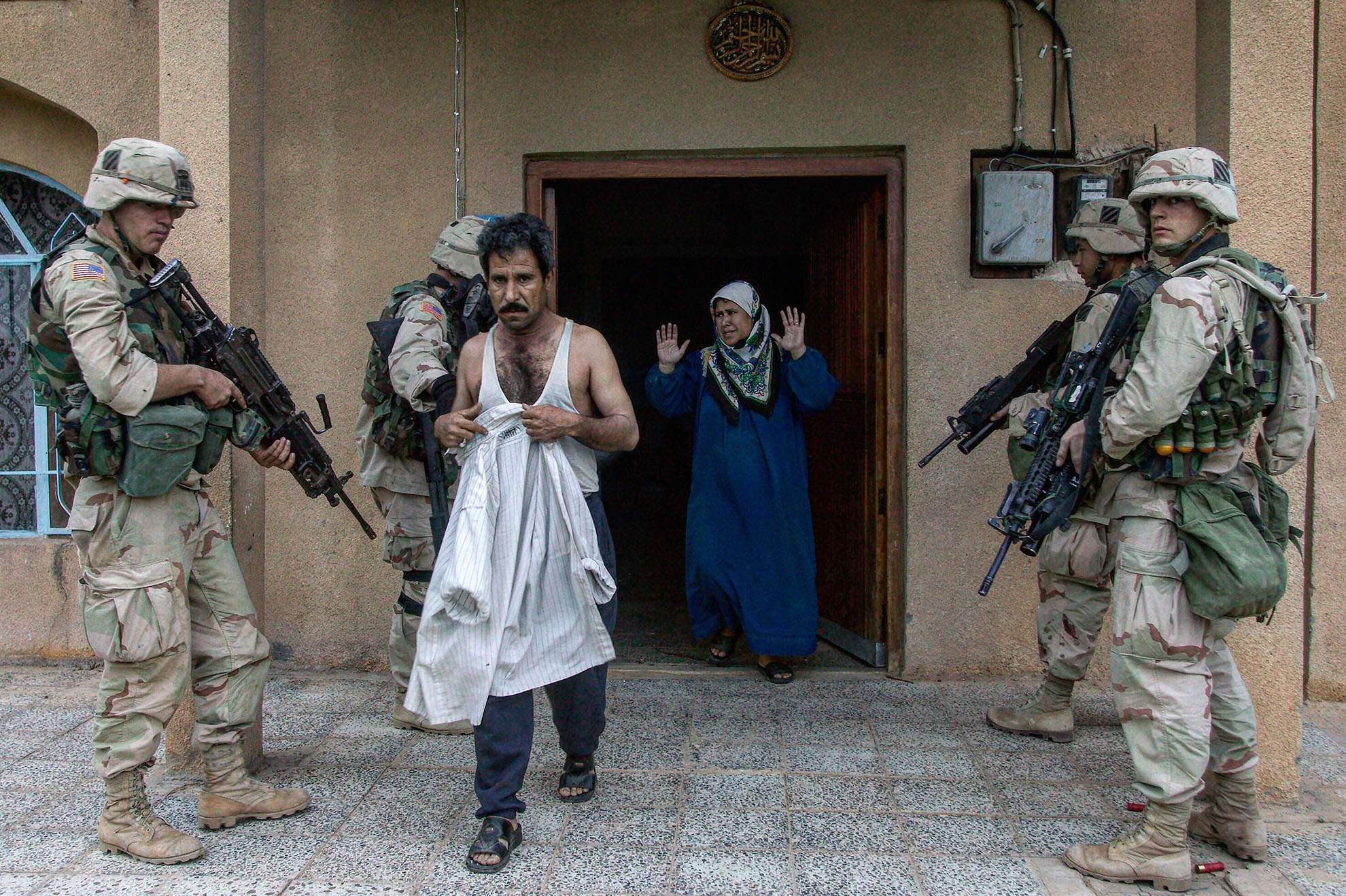 American soldiers at a raid of a residence in Baghdad, Iraq in 2003.
