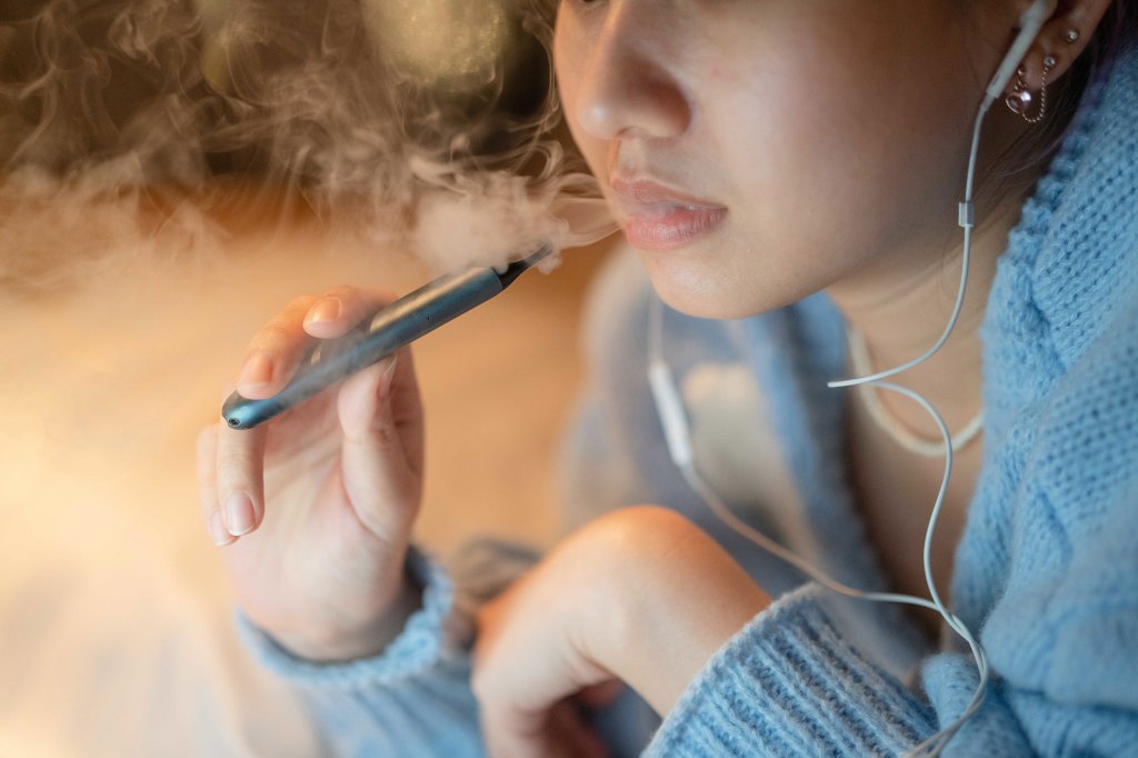 Young woman vaping.