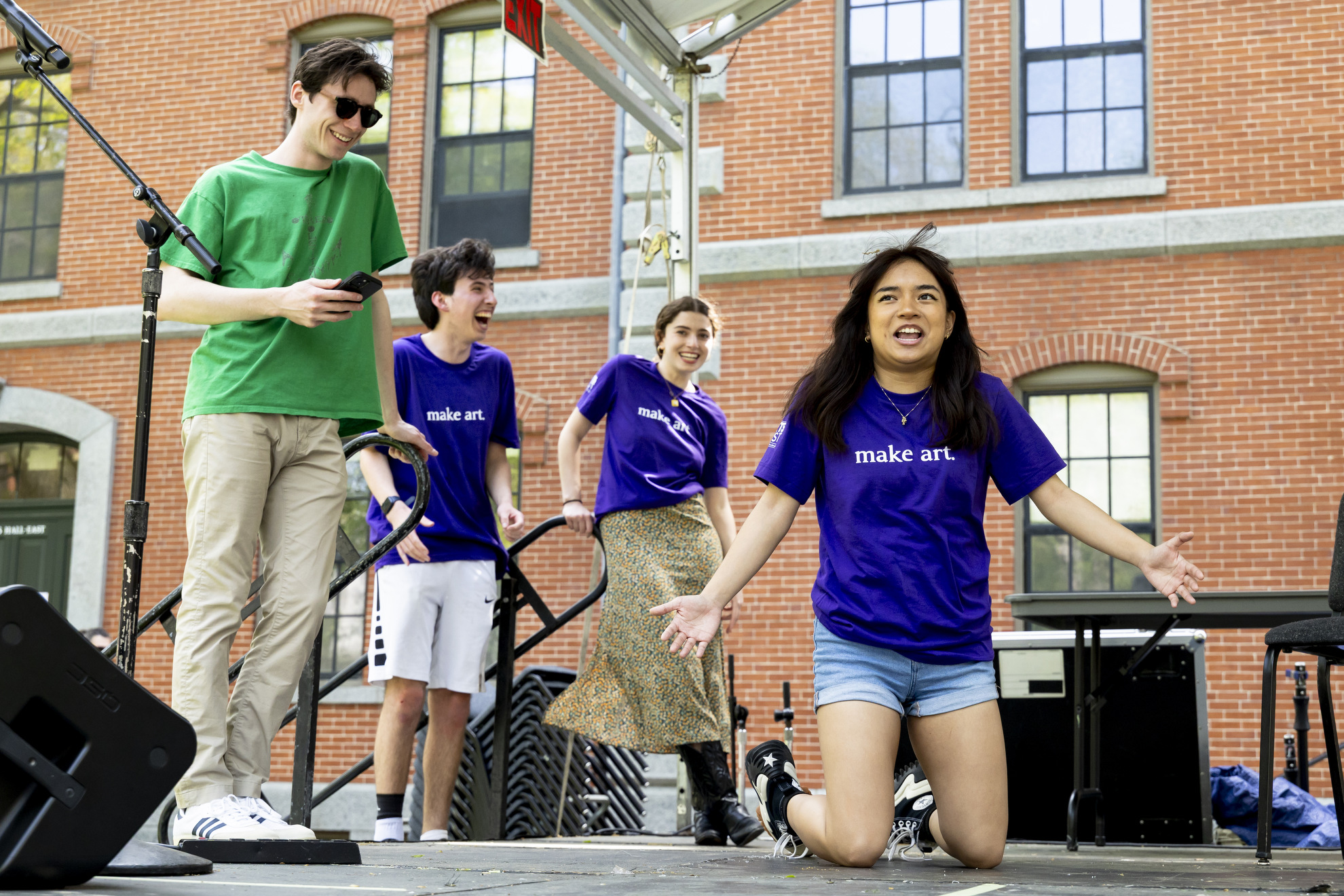 Roseanne Strategos ’25 (right) performs alongside the Three Letter Acronym (TLA) Improv group in Harvard Yard.