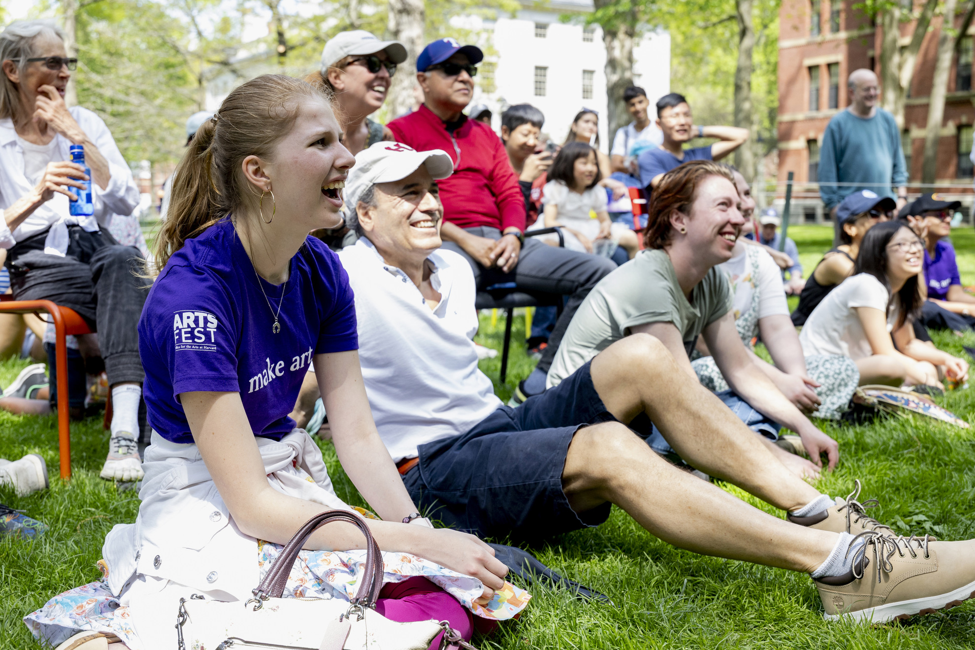 Nathalie Beerelq (left) watches the Three Letter Acronym (TLA) Improv group in Harvard Yard.