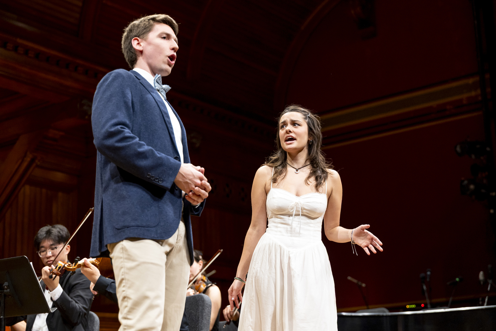 Joshua Halberstadt ’25 (left) and Ava Maha ’28 (right) perform the Act 1 Finale from Mozart’s Don Giovanni during the Harvard College Opera’s performance at Sanders Theatre.