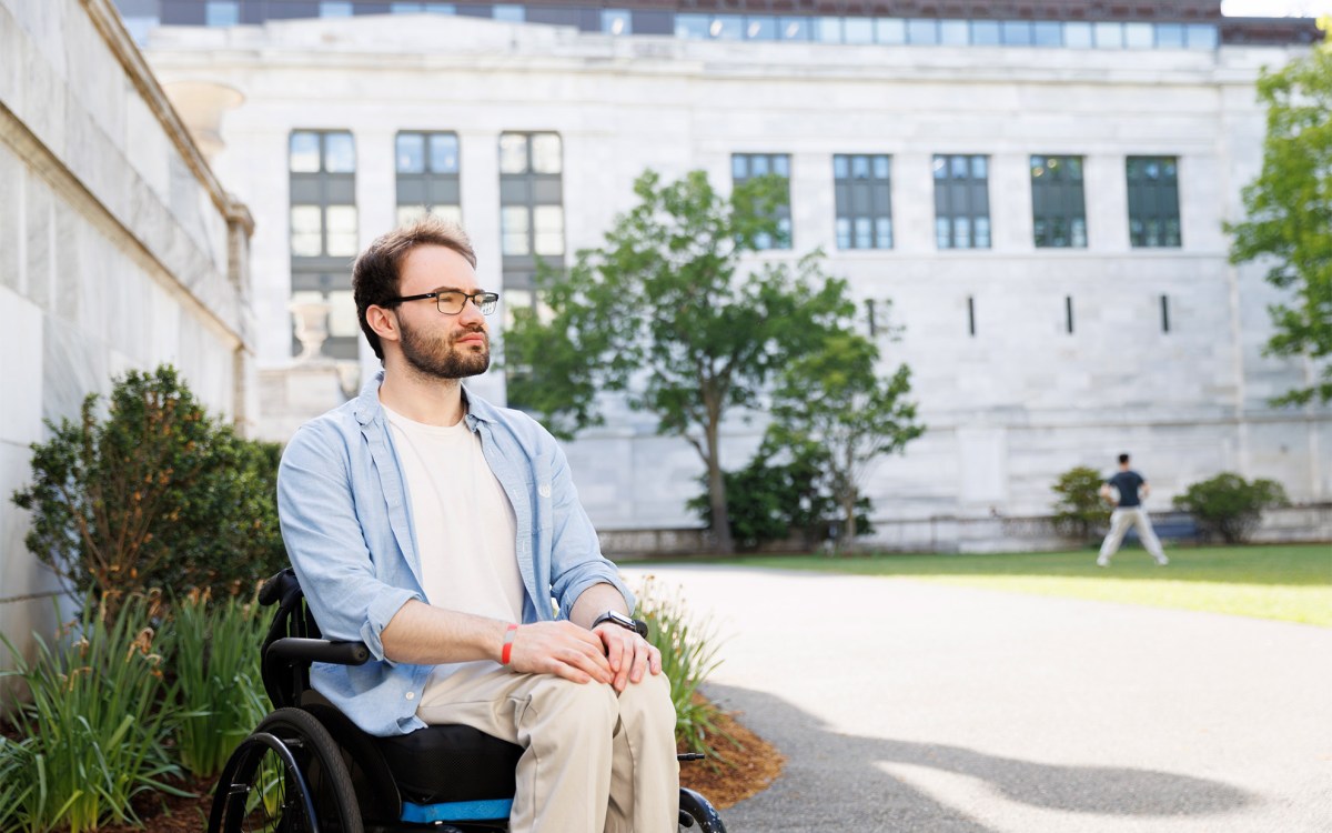 Jason Biundo sitting in a wheelchair in the Harvard Medical School Quad.