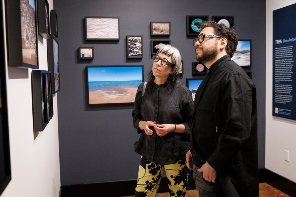 Ilana Boltvinik and Rodrigo Viñas look at their photographs on exhibit at the Peabody Museum of Archaeology and Ethnography at Harvard University.
