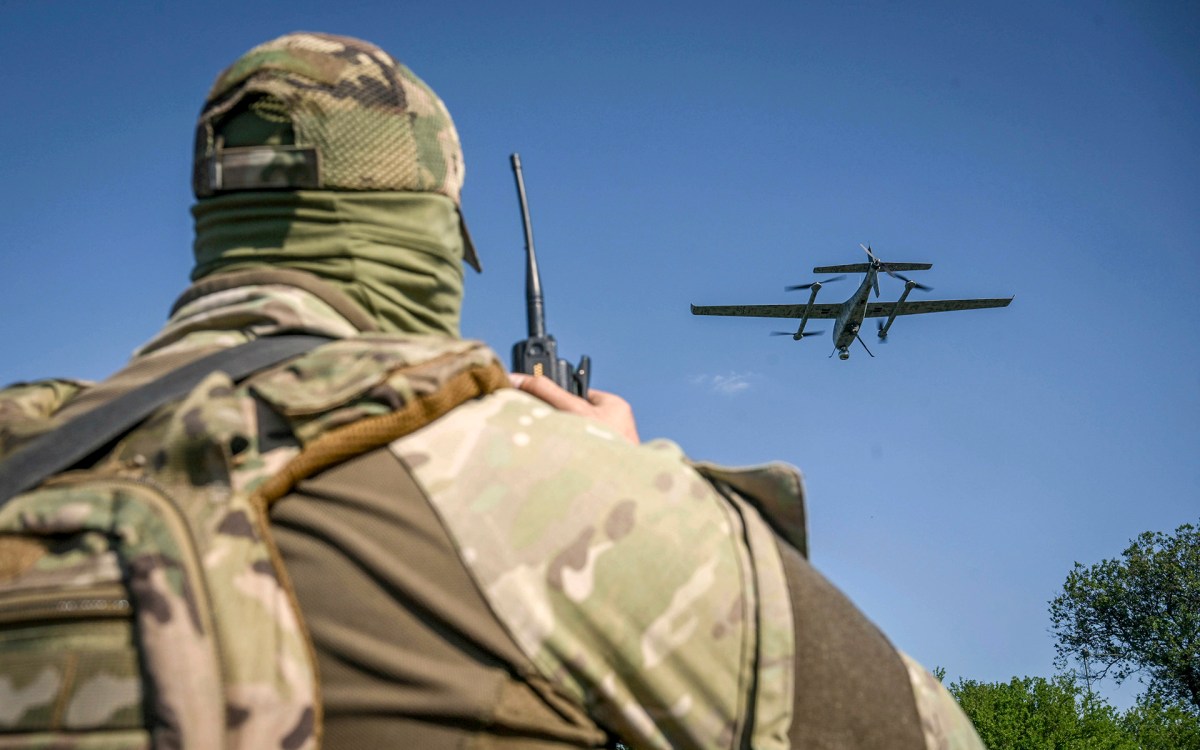 A serviceman launches a drone in Ukraine.