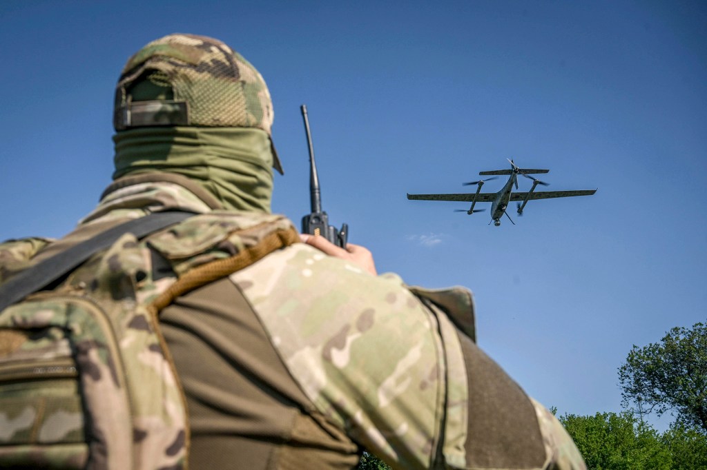 A serviceman launches a drone in Ukraine.