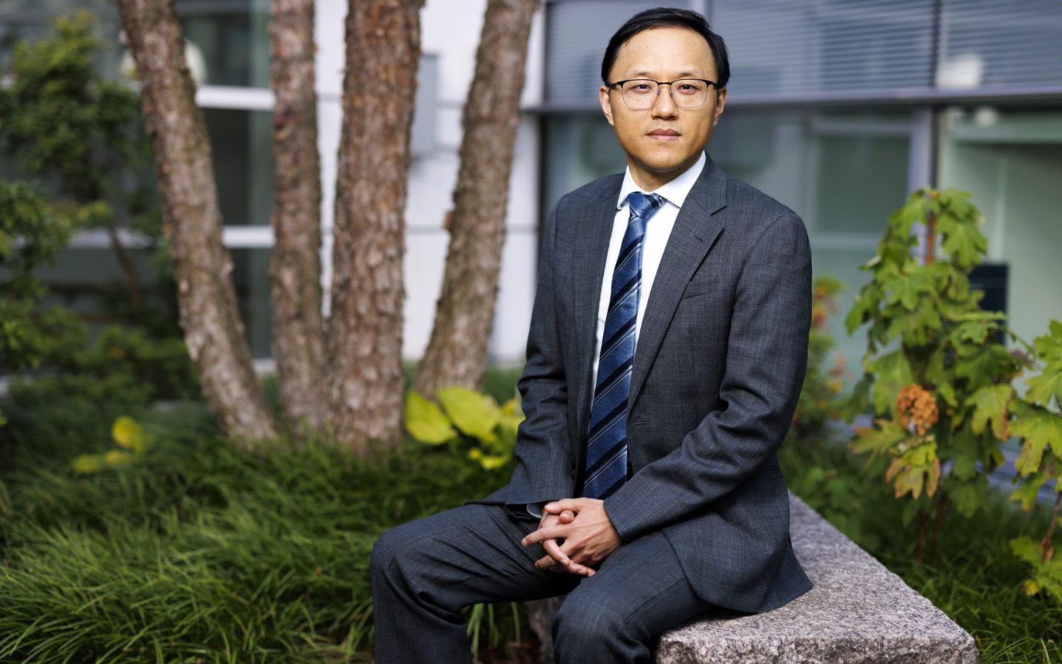 Wei Zhang sits outside.