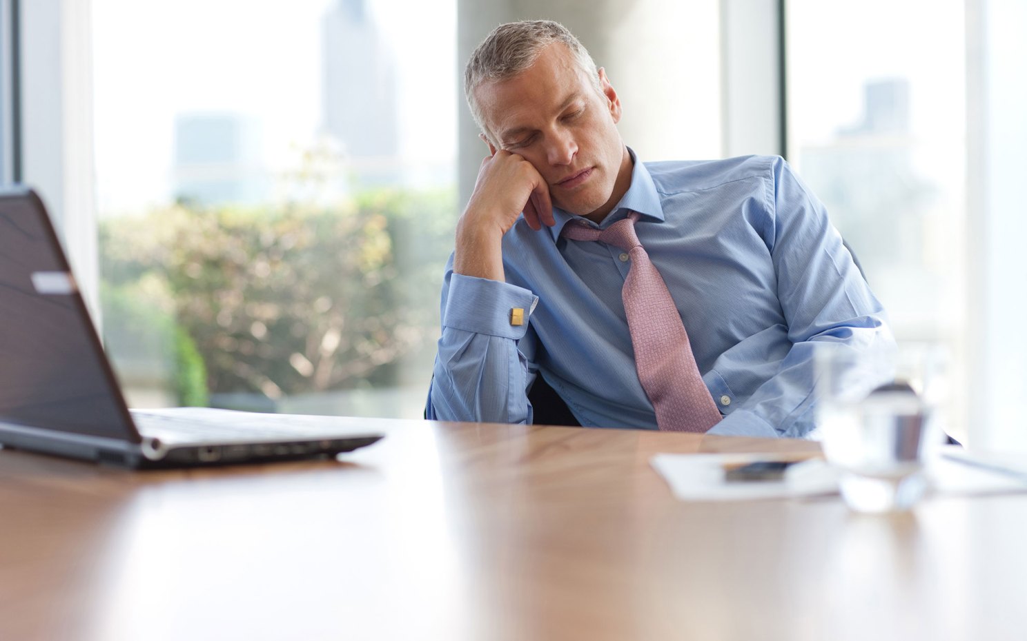 Man sleeping at desk.