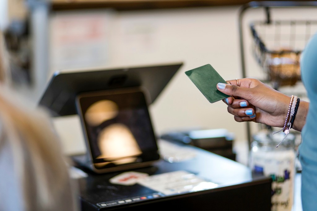 A person pays for a purchase with a credit card. (Nathan Bilow/Getty Images)
