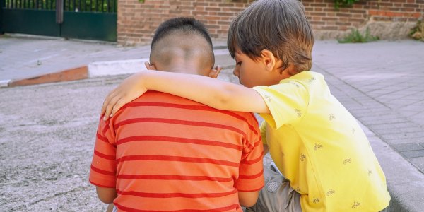 LIttle boy comforting his friend.