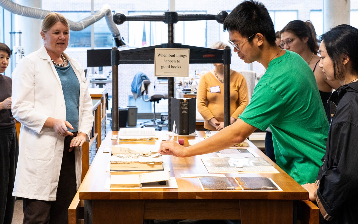 Students examine books from a teaching collection.