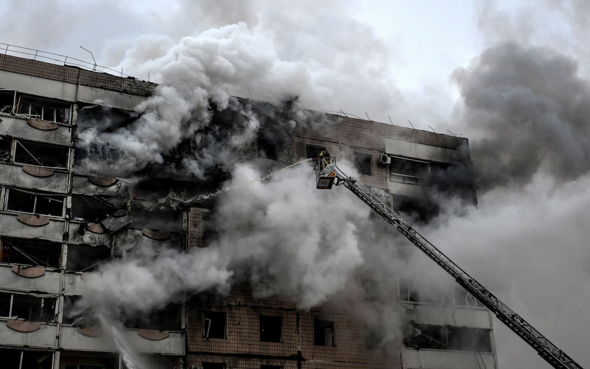 A firefighter uses an aerial ladder to suppress a fire in an apartment block hit by a Russian guided aerial bomb in Zaporizhzhia, Ukraine, on December 17, 2025.