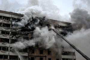 A firefighter uses an aerial ladder to suppress a fire in an apartment block hit by a Russian guided aerial bomb in Zaporizhzhia, Ukraine, on December 17, 2025.