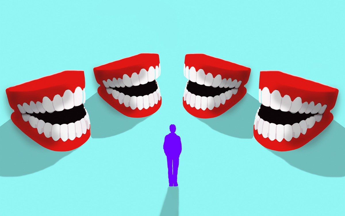 Man surrounded by laughing fake teeth.