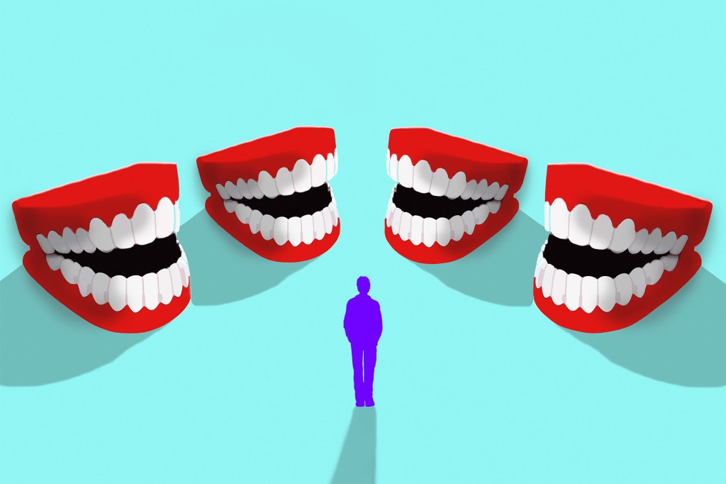 Man surrounded by laughing fake teeth.