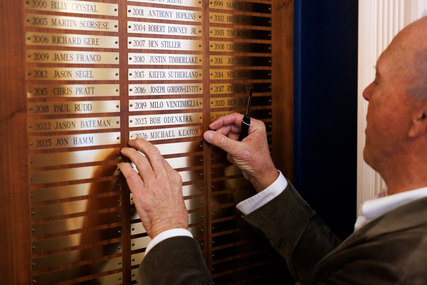 Michael Keaton installing the “2026 Michael Keaton” plaque. Hasty Pudding Man of the Year Michael Keaton tours Farkas Hall.