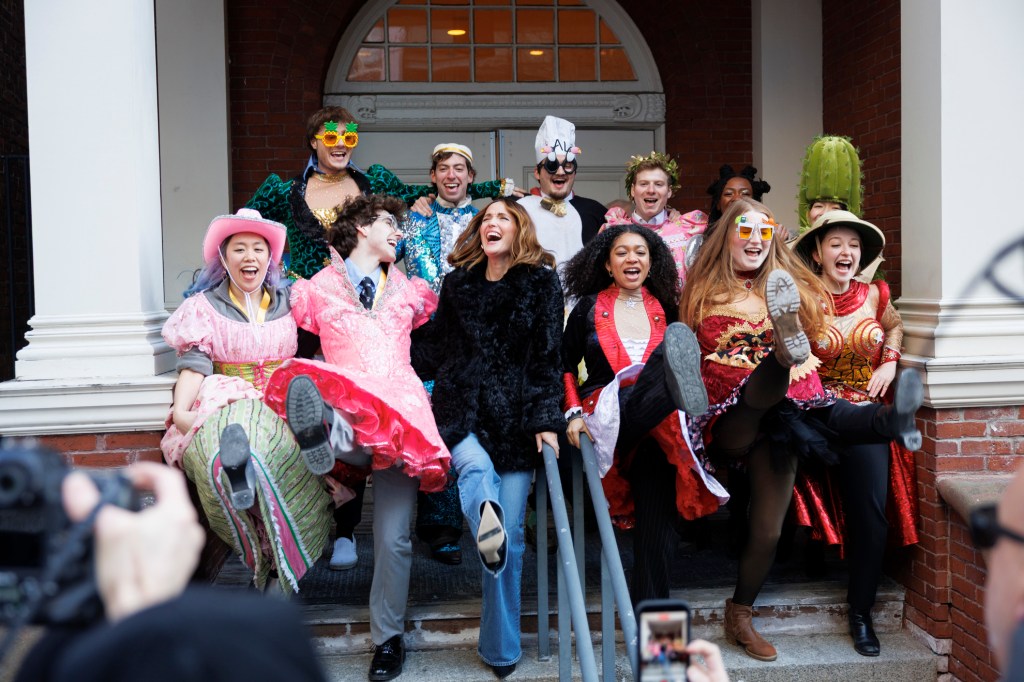 Rose Byrne (center) and members of the Hasty Pudding Theatricals do a kick line together in front of Farkas Hall. V