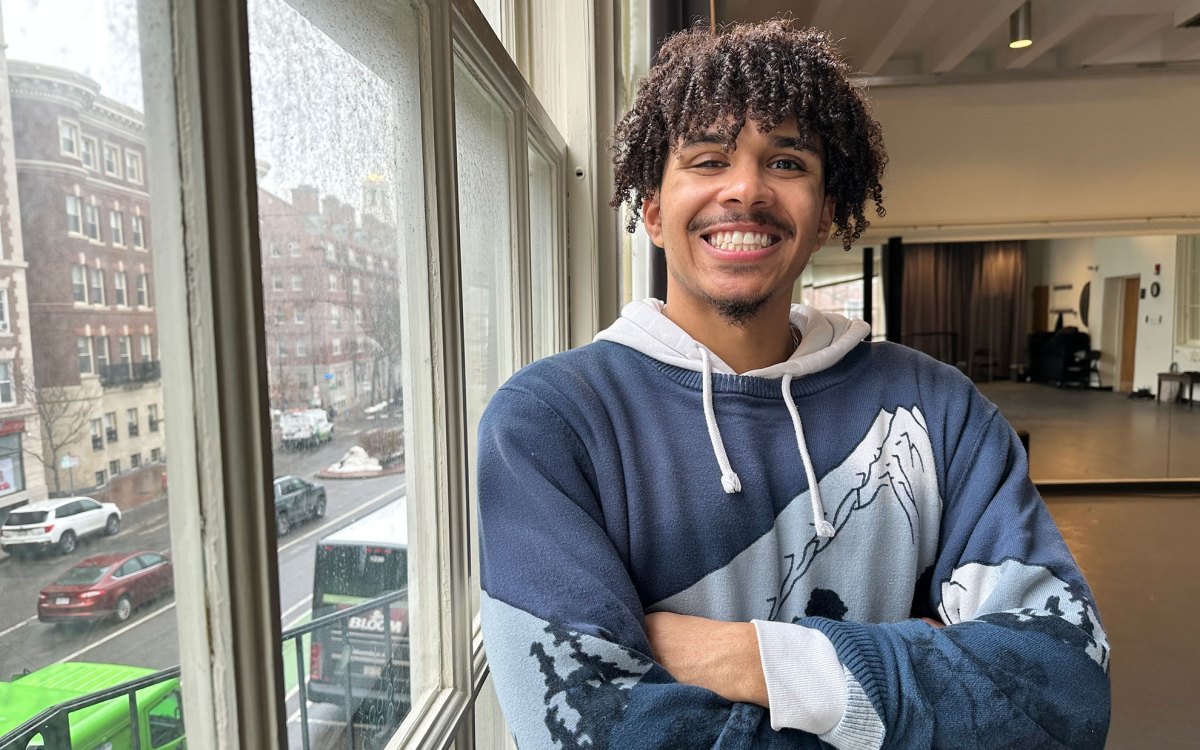 Dree Palimore standing for portrait with arms folded.