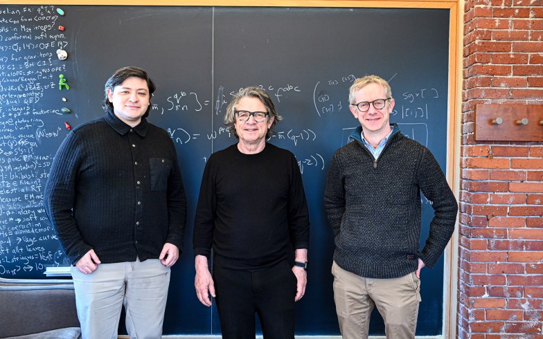 Alfredo Guevara, Andrew Strominger, and David Skinner in front of a chalkboard.