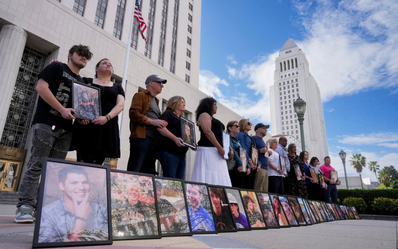 Parents of children who have died due alleged social media harms hold photos of their at the Los Angeles Superior Courthouse.
