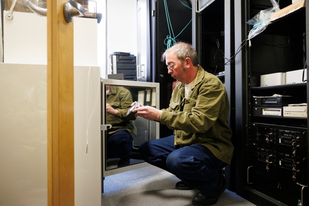 Jason Bitner, Media Technician IV, putting a VHS tape into the oven. 