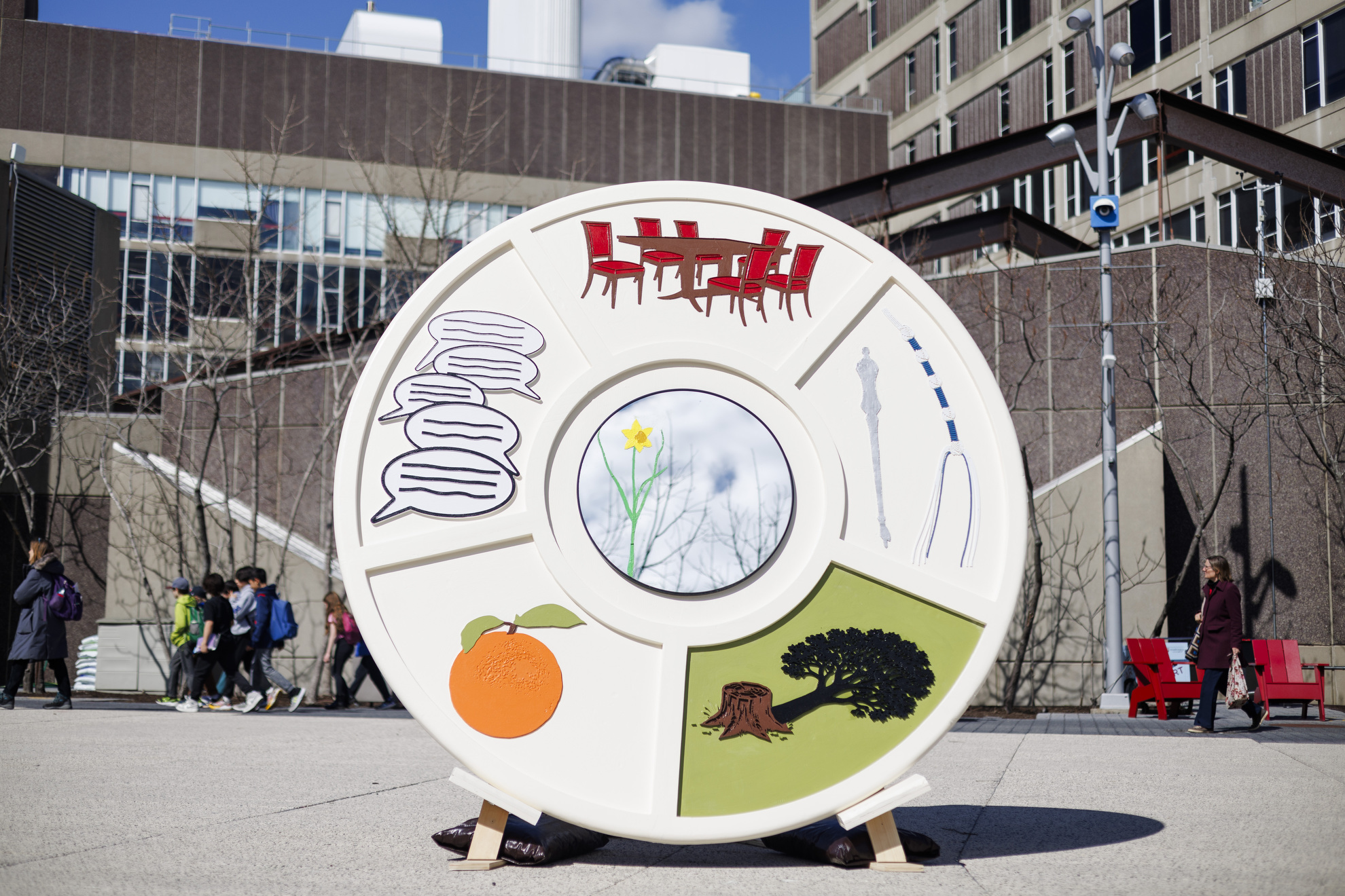 Giant Seder plate sculpture on Harvard's campus with colorful custom images.