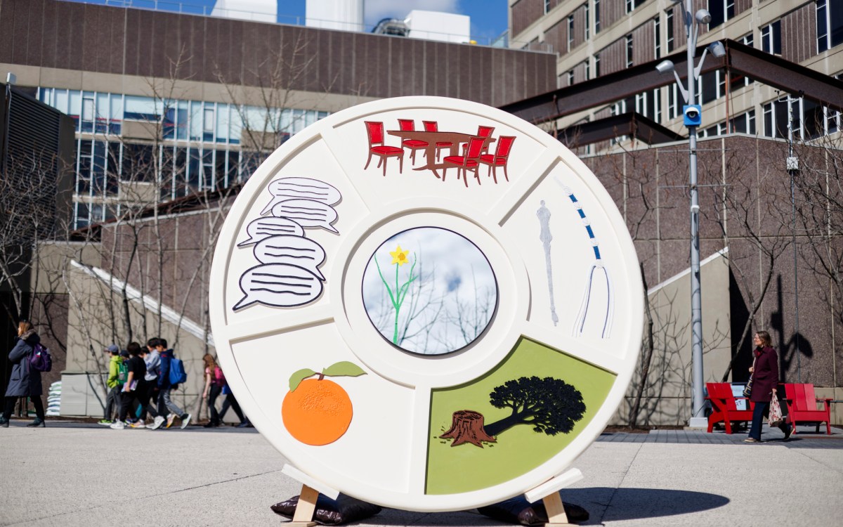Giant Seder plate sculpture on Harvard's campus with colorful custom images.
