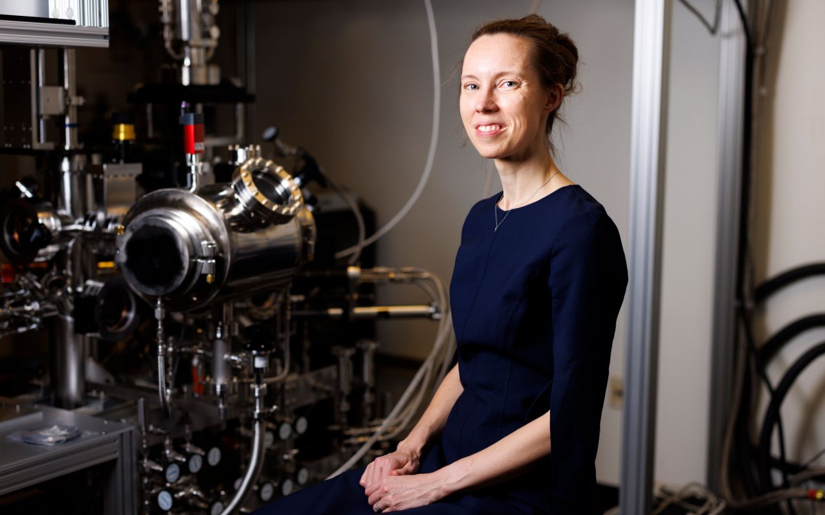 Karin Öberg is seen in a portrait near a vacuum instrument in her lab.