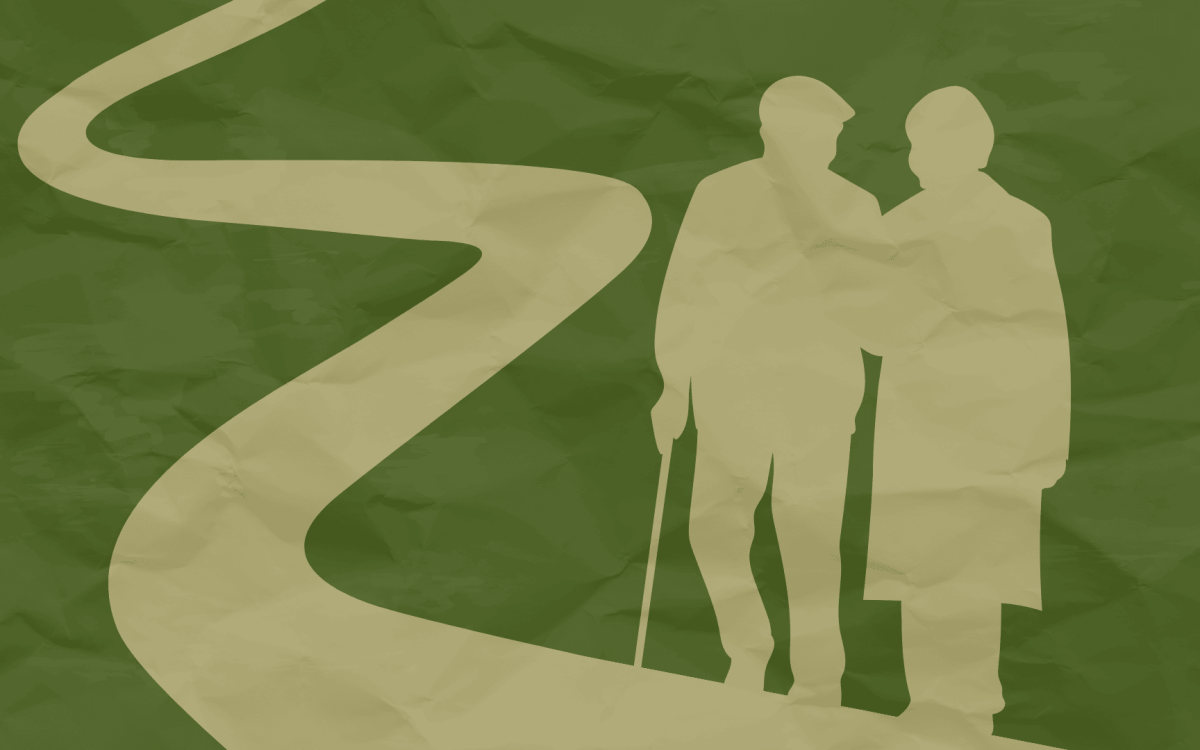 two elderly people walking on a path