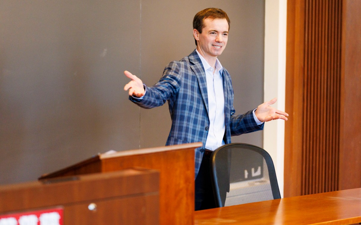 Marco Basile speaking in front of a group.