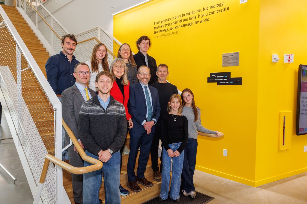 President Alan Garber and Dean David David Parkes stand with members of the Troper Wojcicki family.