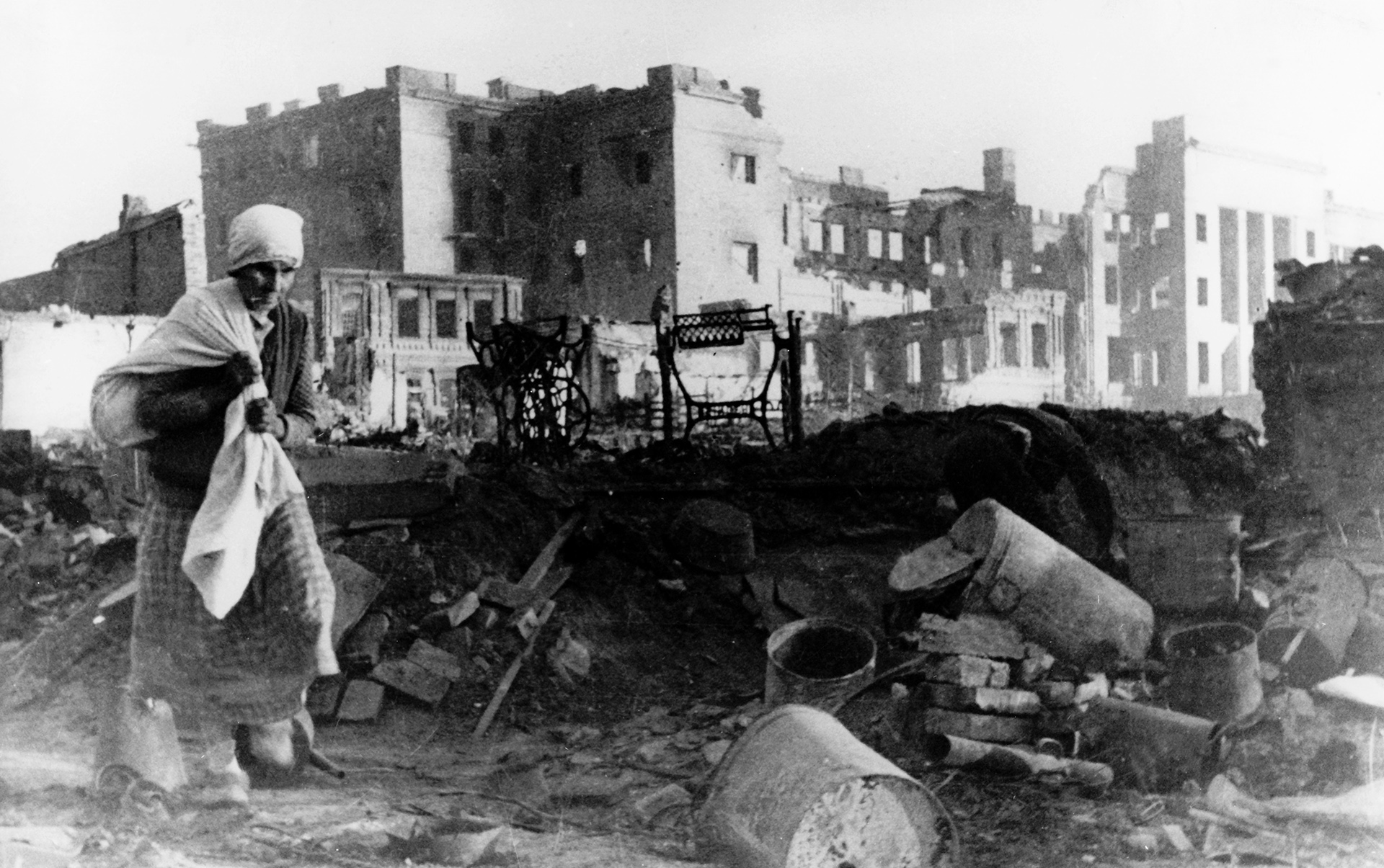 Soviet woman searches for her possessions under the rubble of her home in Stalingrad.