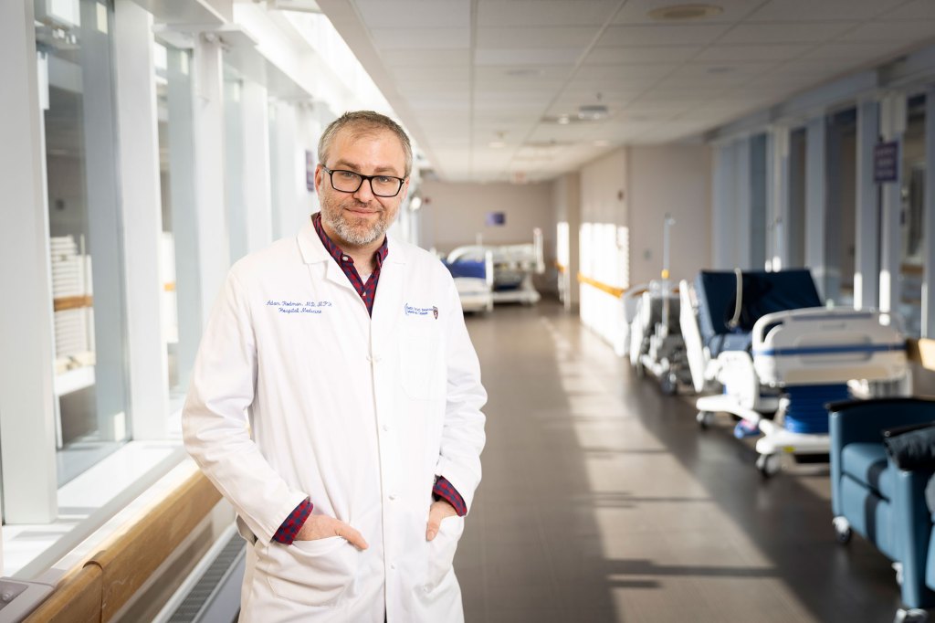 Adam Rodman standing in hospital corridor.