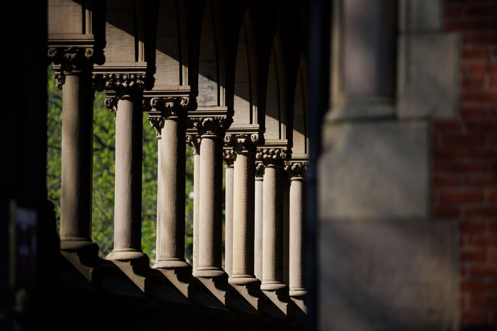 Sunlight beams through the columns of Memorial Hall.