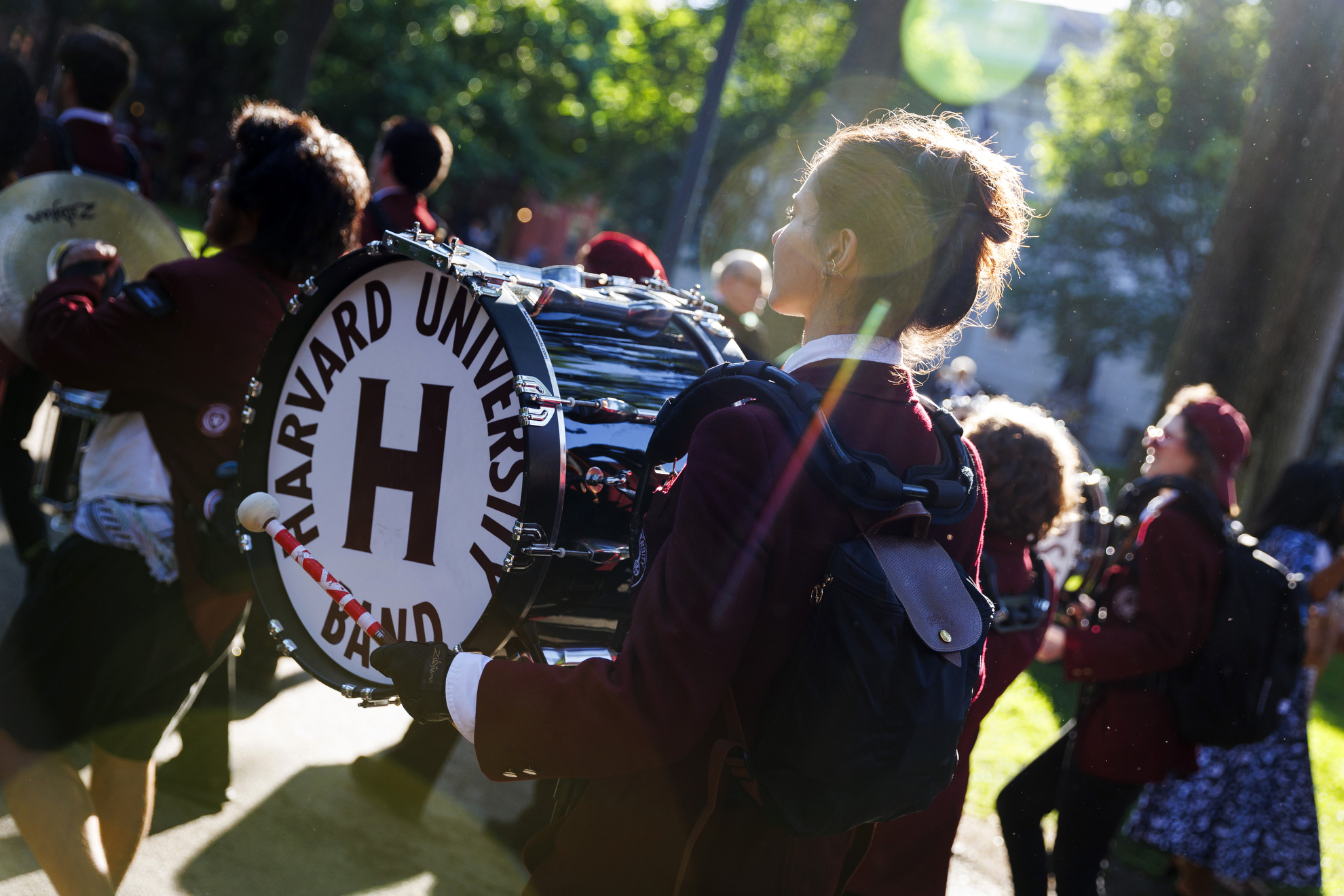 The drummer from the Harvard University Band processes past.