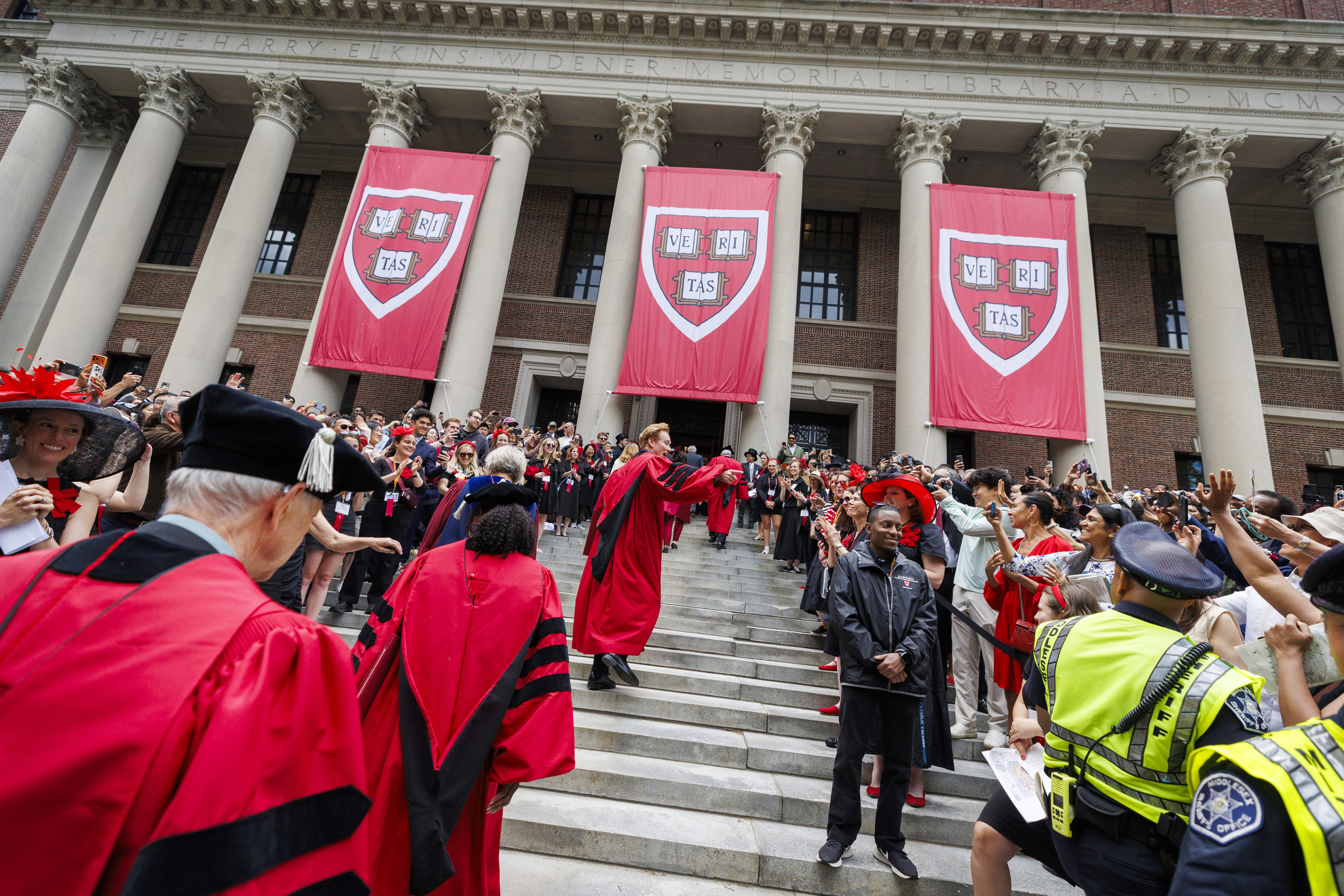 Conan O’Brien walks the steps of Widener Library.