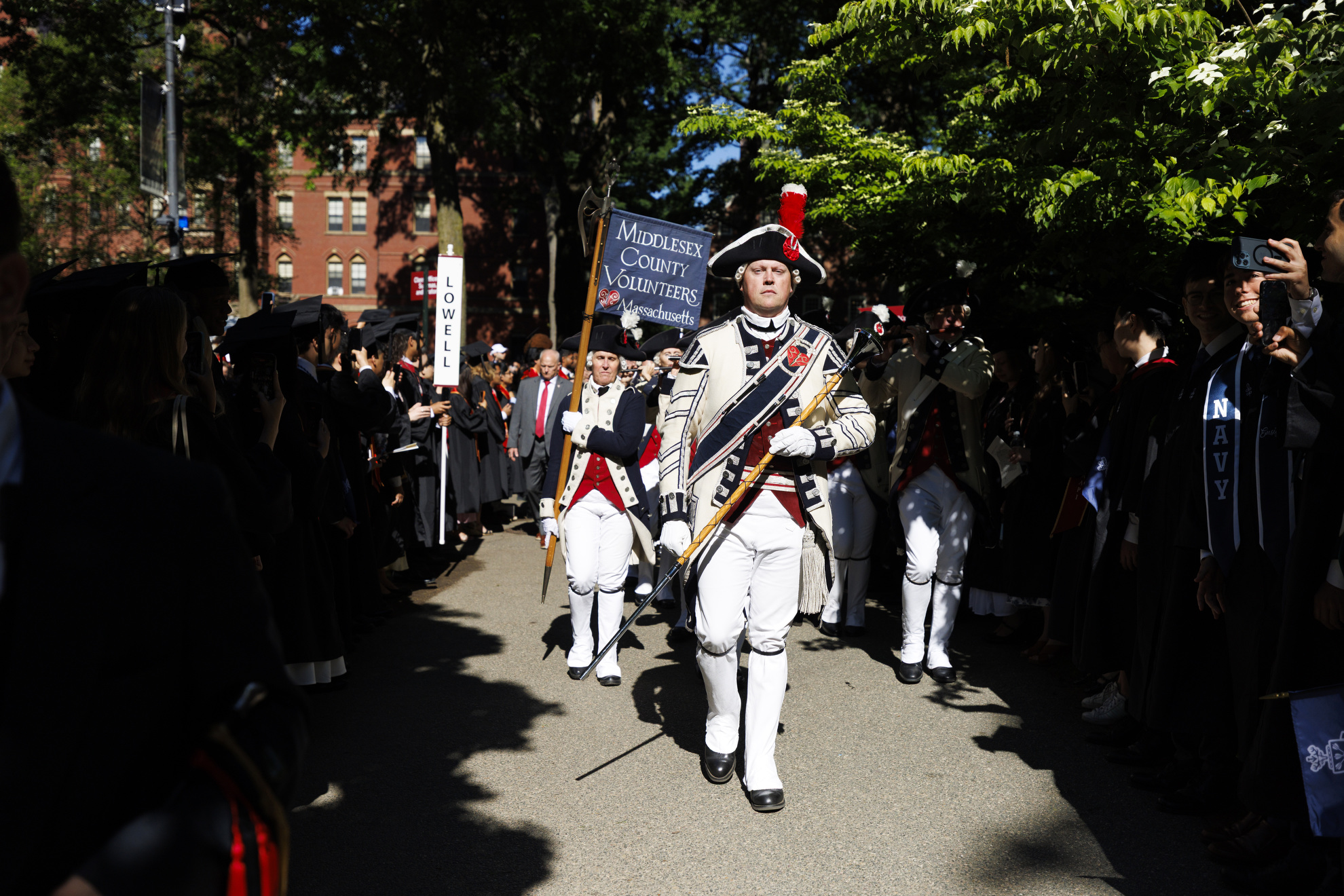 John Nichols, a Harvard employee, leads his group, the Middlesex County Volunteers Fifes and Drums, into Harvard Yard