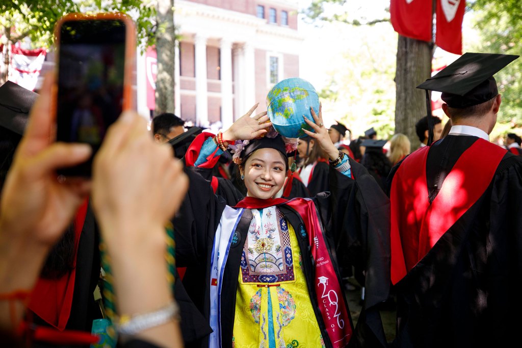 Ngoc Nguyen, graduate of Harvard Kennedy School, poses while wearing traditional imperial court dress for the empress from the Nguyen Dynasty in Viet Nam.