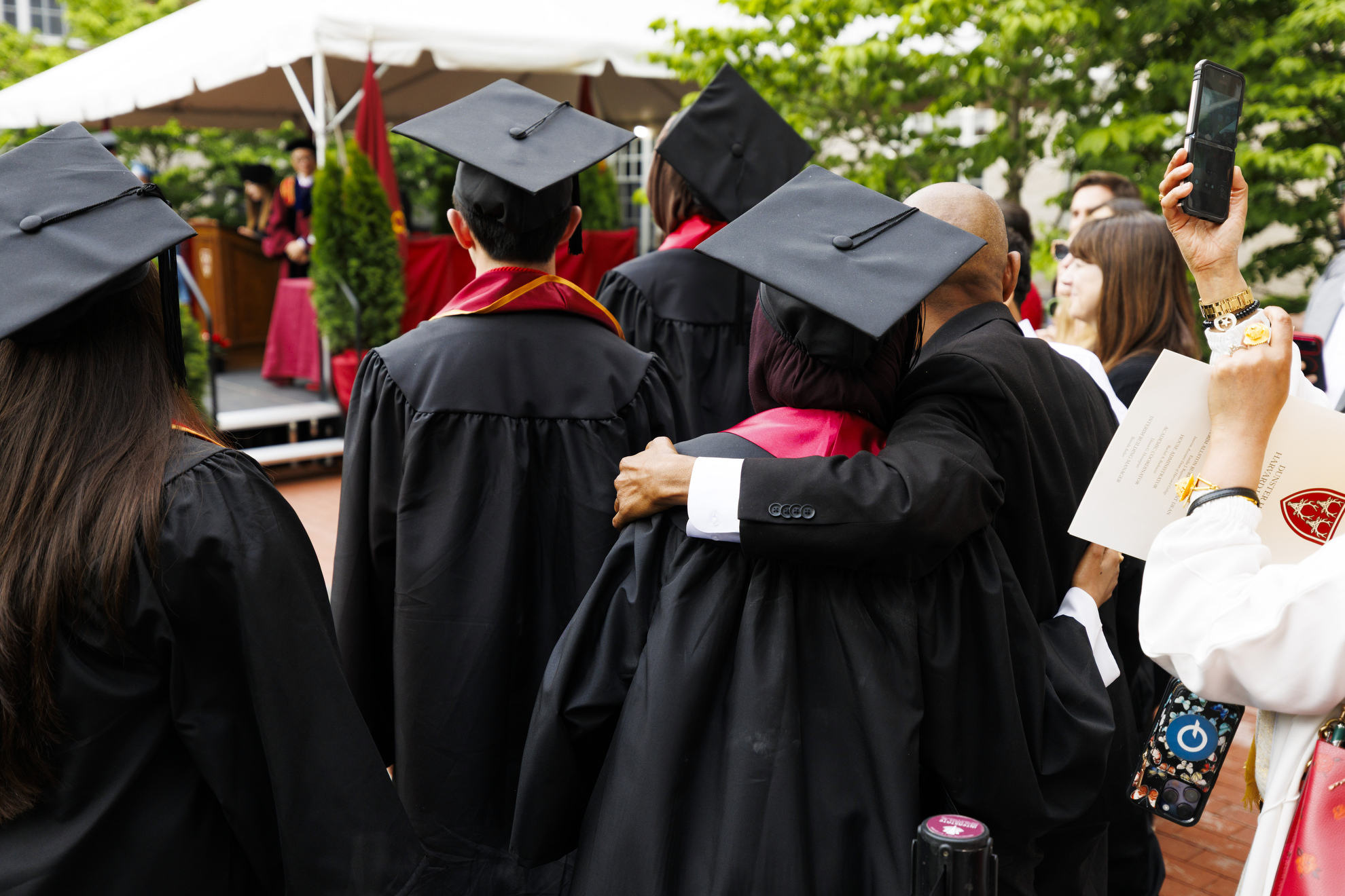 A graduate embraces a family member during a ceremony for graduates from the Class of 2026, at Dunster House.