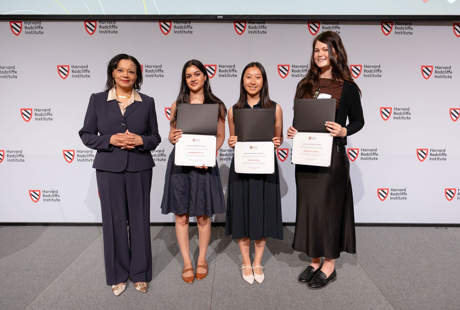 Harvard Radcliffe Dean Tomiko Brown-Nagin stands with the three 2026 Fay Prize winners (left to right) Dhati Oommen, Mira Hu Jiang, and Jessica Jenkins