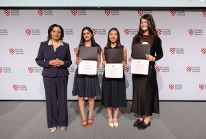 Harvard Radcliffe Dean Tomiko Brown-Nagin stands with the three 2026 Fay Prize winners (left to right) Dhati Oommen, Mira Hu Jiang, and Jessica Jenkins